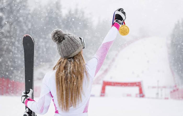 Skier Holding Up Medal